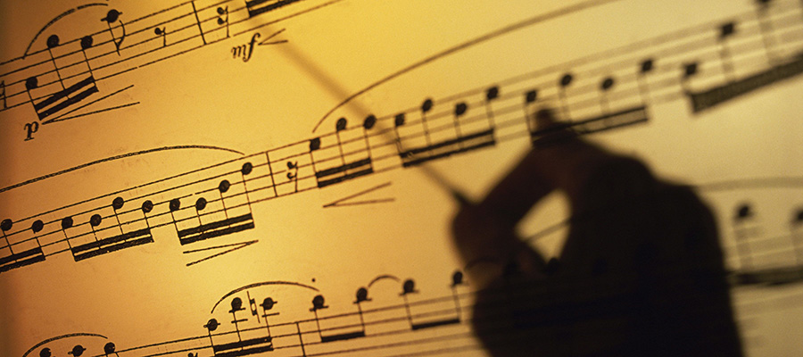 Conductor's hand over sheet music